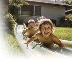 two kids playing artificial grass yard